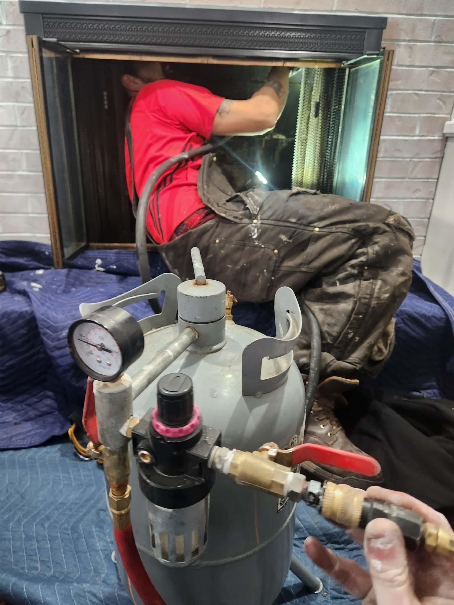 Technician performing chimney repair inside firebox